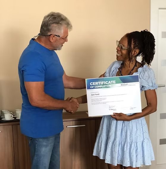 Jan Ford receiving Kaqun Certificate of Completion from Dr. Robert Lyons